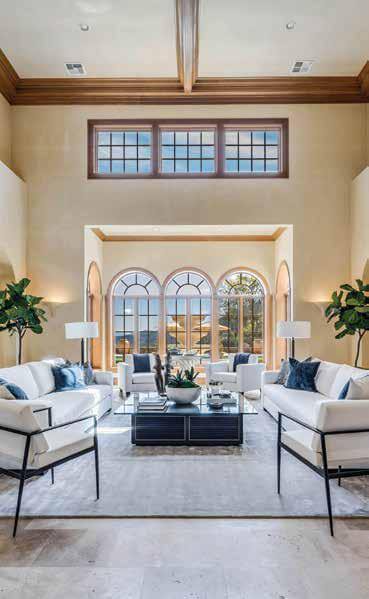 The first floor of the main residence is warm and serene, with travertine floor tile and vaulted ceilings