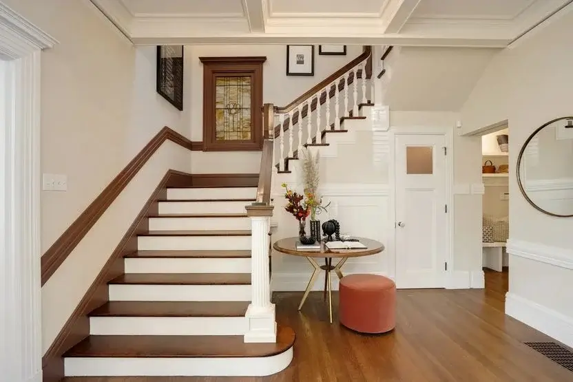 Staircase in entry, with stained-glass window and coffered ceilings(Realtor.com)