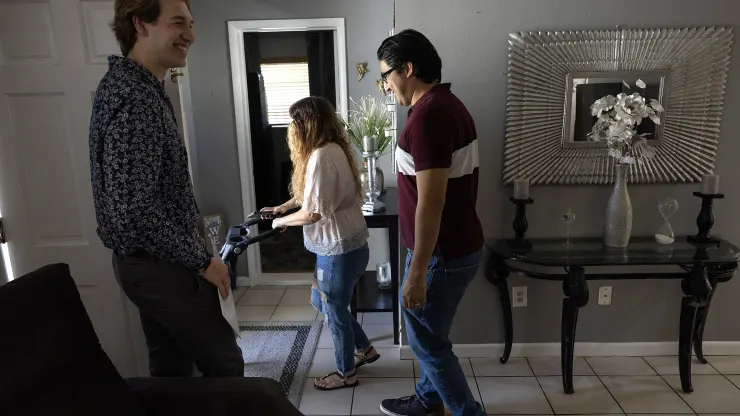 Ryan Ratliff (L), Real Estate Sales Associate with Re/Max Advance Realty, shows Ryan Paredes (R) and Ariadna Paredes a home for sale on April 20, 2023 in Cutler Bay, Florida