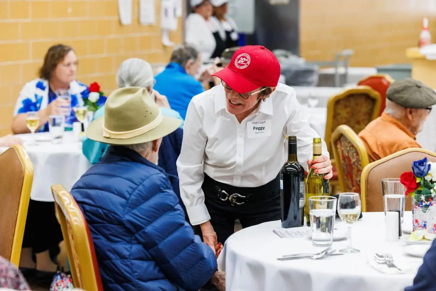 A volunteer serves wine during the Annual Celebrity Chefs luncheon for residents of the Yountville<br />
Veterans Home on Wednesday, November 6.<br />
Nick Otto/Register