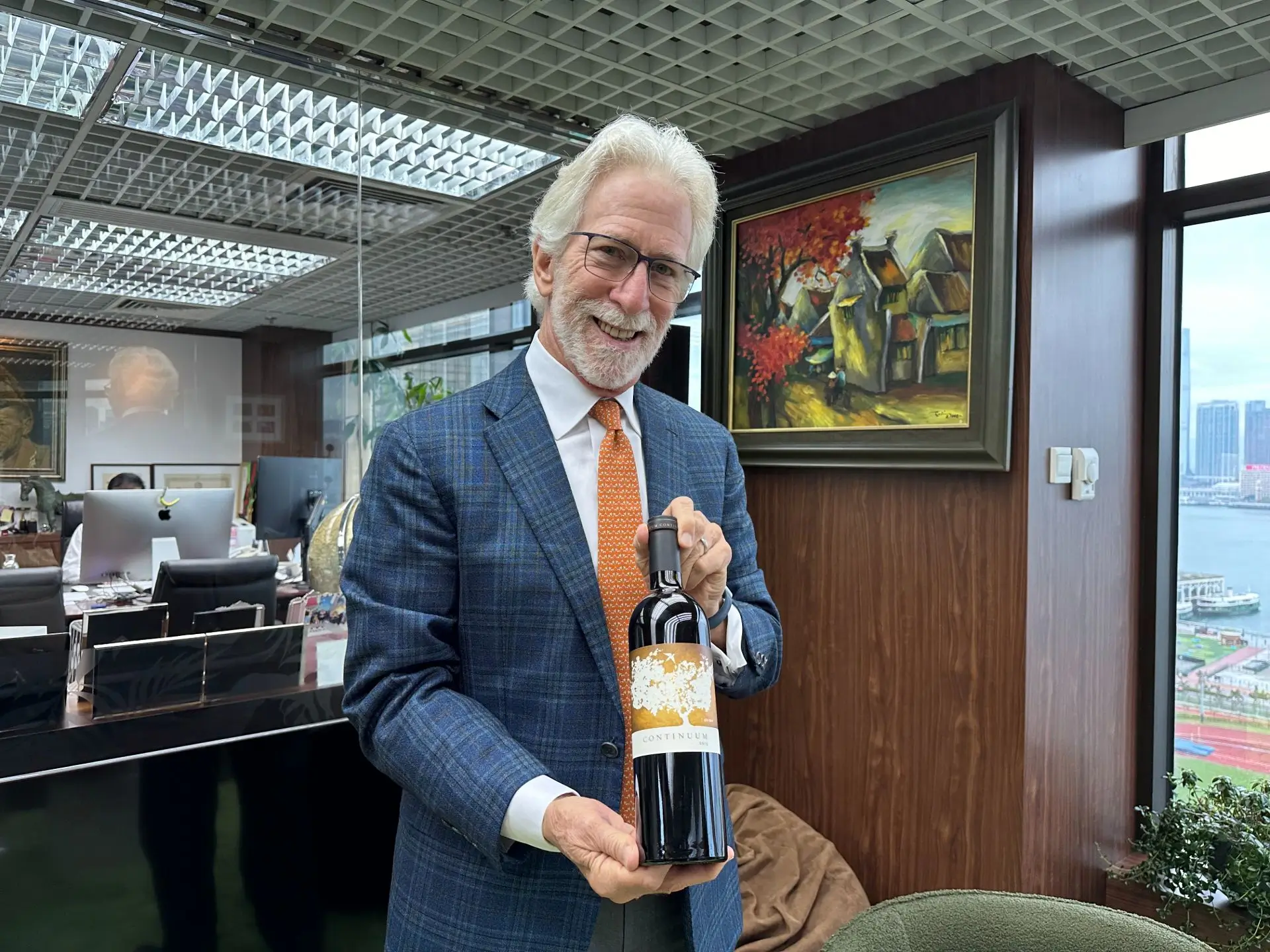 Tim Mondavi holding a bottle of his Continuum in Hong Kong at local importer Links Concept's office</p>
<p>