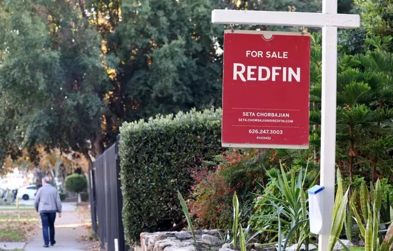 A sign is posted outside of a condominium that is for sale on December 19, 2022, in Los Angeles. California was one of the most popular states to move to in 2022, according to a NAR report.